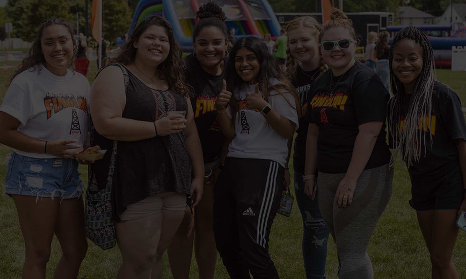 group of female students giving thumbs up at orientation