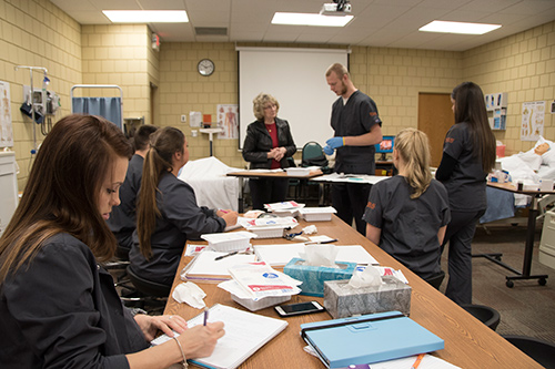 Nursing students learning hands-on.