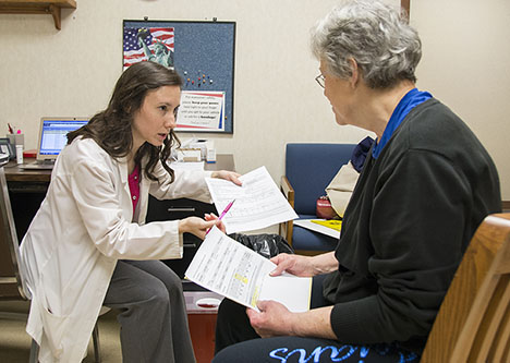 A pharmacist works with a patient at the Medication Therapy Management Center