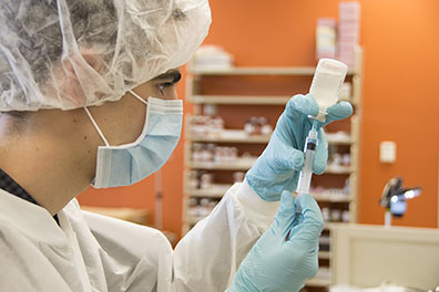 pharmacy student pulling medicine with a syringe