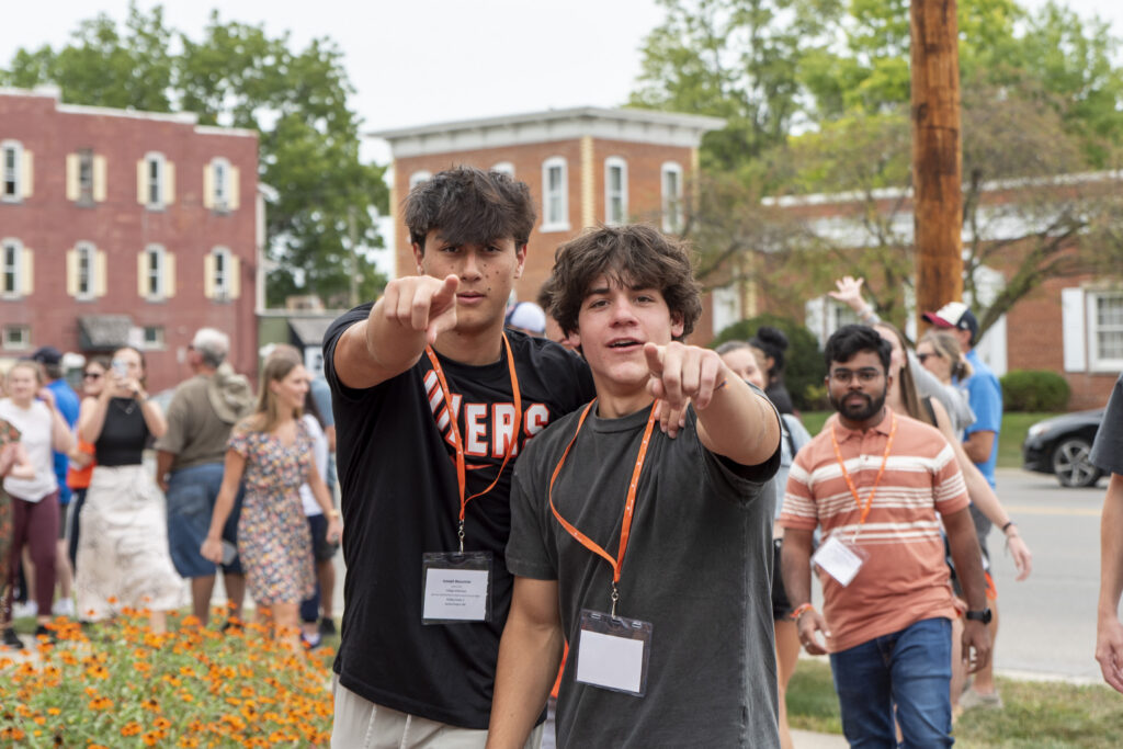 Two students pointing.