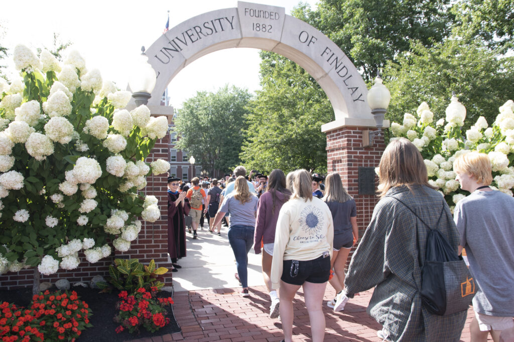 Students walking through the Griffith Memorial Arch.