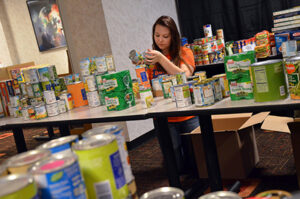 Student Participating in Helping Hands Food Drive At UF