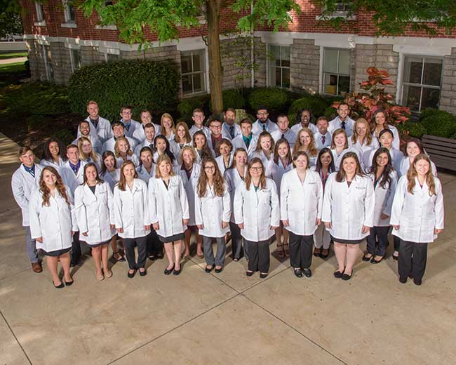 Year 4 pharmacy students in their white coats